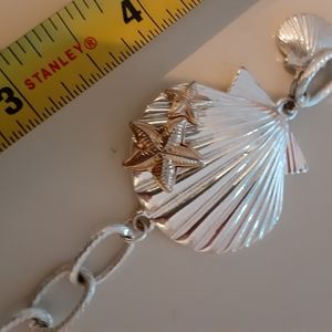 Bracelet with toggle clasp in silver tone with seashell design.